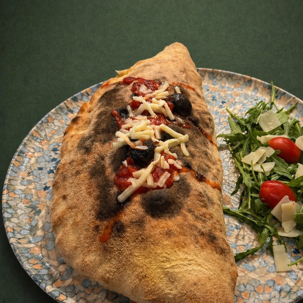 Wood-fired calzone with rocket salad