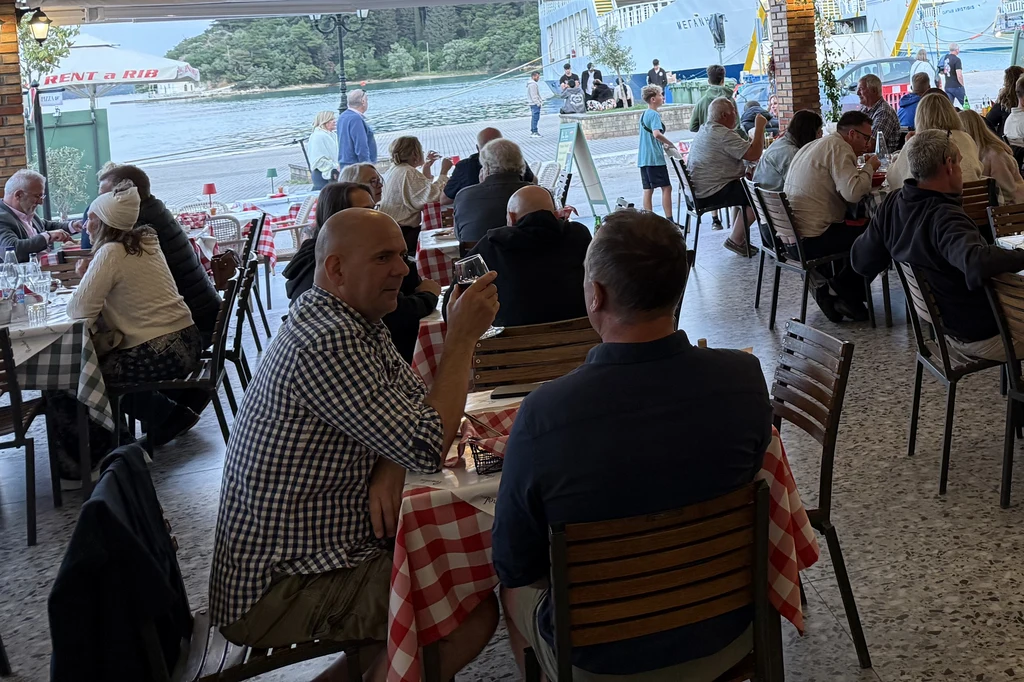Guests dining with a view of Nydri harbour