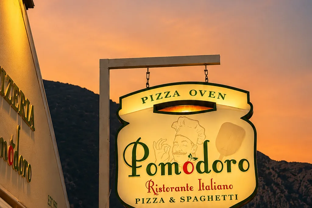 Pomodoro pizza oven sign at sunset