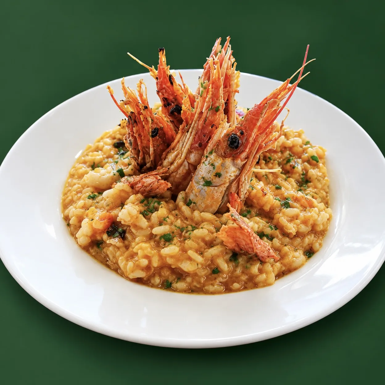 Seafood risotto topped with red prawns